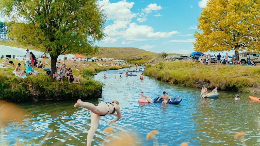 Campers by the river at Splashy Fen in the Drakensberg